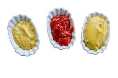 Directly above shot of multi colored candies against white background