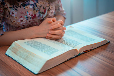 Midsection of woman reading book