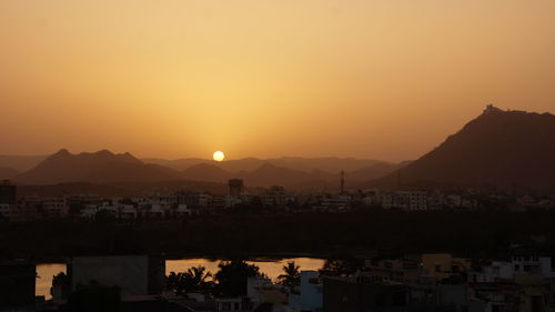 Scenic view of mountains against clear sky during sunset