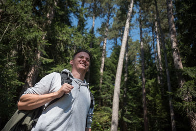 Low angle view of young woman in forest