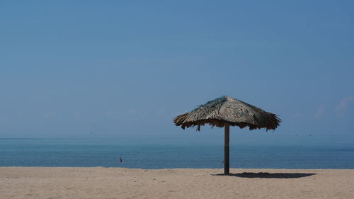 Lifeguard hut on beach against sky