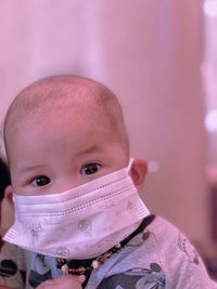 Portrait of cute baby boy wearing mask