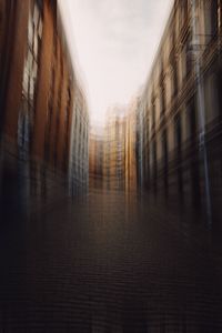 Street amidst buildings against sky in city