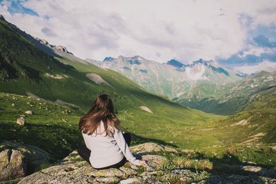 Rear view of woman looking at mountains