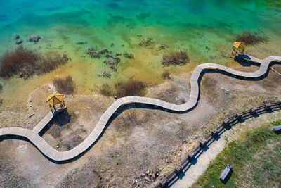 High angle view of plants by road against sea