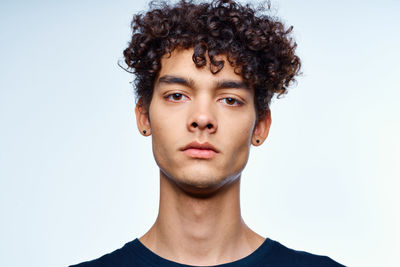 Portrait of young man against white background