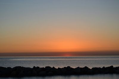 Scenic view of sea against clear sky during sunset