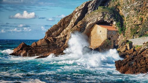 Sea waves splashing on rocky shore