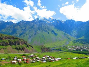 Scenic view of mountains against cloudy sky