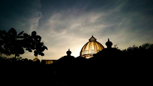 Low angle view of built structure against sky at sunset