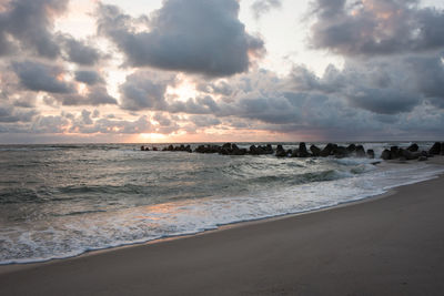 Scenic view of beach against sky during sunset