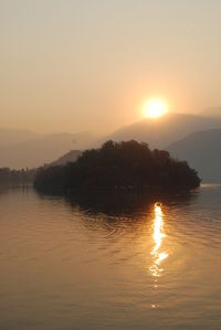 Scenic view of lake against sky during sunset