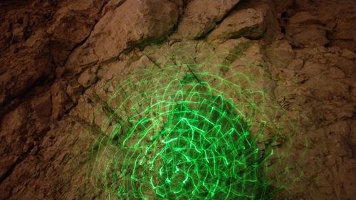 Low angle view of illuminated rock in cave