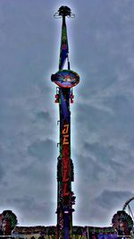 Low angle view of communications tower against cloudy sky