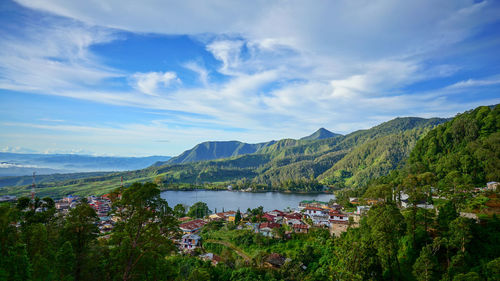 Scenic view of lake and mountains against sky