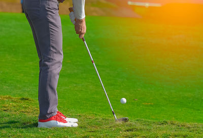 Low section of man standing on golf course