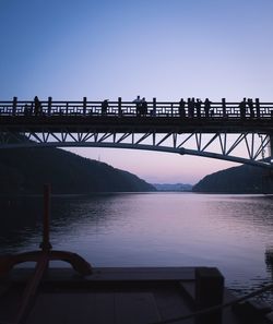 Bridge over river at sunset