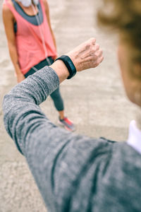 Woman checking smart watch while standing on pier