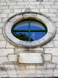 Low angle view of window on wall