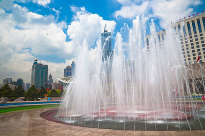 Panoramic view of fountain in city against sky