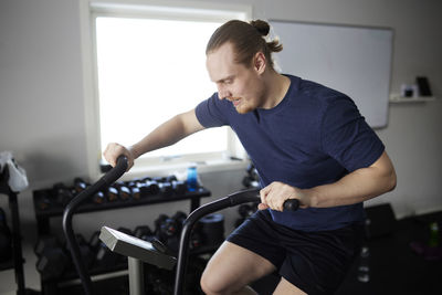 Man on exercise bike at gym