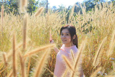 Portrait of woman standing in field