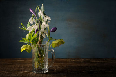 Flowers in glass on table at home