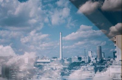 Modern buildings against cloudy sky