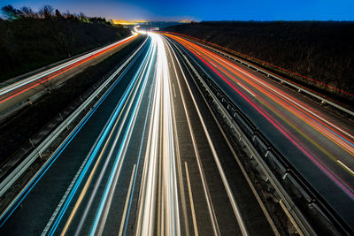 High angle view of light trails on highway at night