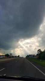 Car on road against dramatic sky