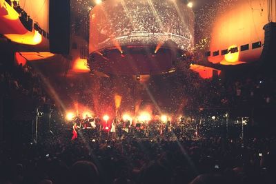 People enjoying concert at night