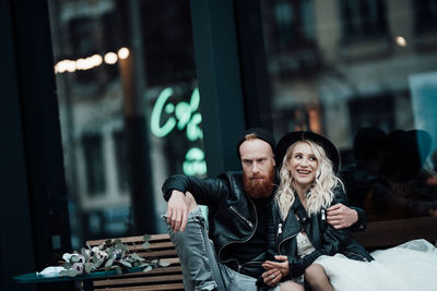 Young couple sitting on window