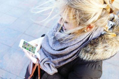 High angle view of woman using mobile phone on street