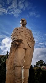 Low angle view of statue against blue sky