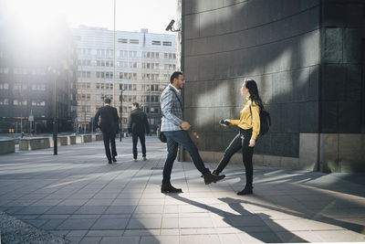 Man and woman greeting using feet