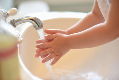 Midsection of woman in bathroom at home