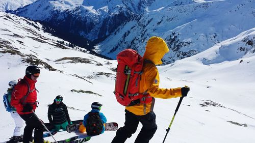 Hikers on snowcapped mountain