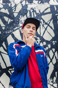 Portrait of mid adult man standing against wall