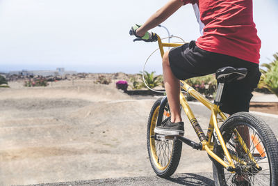 Low section of boy riding bicycle at sports ramp