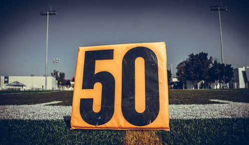 Information sign on street against sky