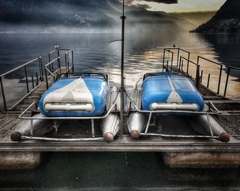 Boats moored in lake against sky