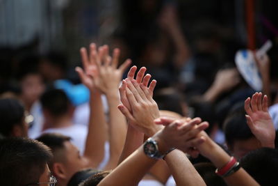 Crowd clapping hands during event