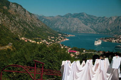 Clothes drying on clothesline by mountains against sky