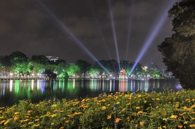 Hoan kiem lake with turtle tower decorated by bright lights at night