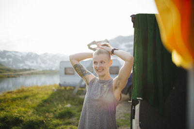 Smiling woman standing at camping site