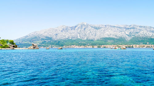 Scenic view of sea against clear blue sky