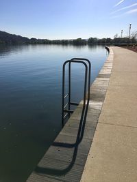 Pier on lake against sky