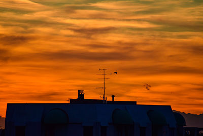 Low angle view of silhouette building against sky during sunset