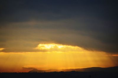 Scenic view of silhouette landscape against sky at sunset