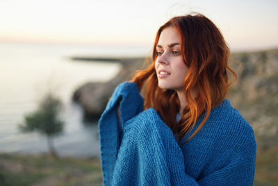 Beautiful young woman looking away